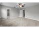 Spacious main bedroom featuring carpet, a ceiling fan, and en-suite bathroom entrance at 2057 Big Falls Dr, Wendell, NC 27591