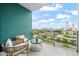 Enjoy the city view from this private balcony with seating and a turquoise accent wall at 214 Hunt St # 701, Durham, NC 27701