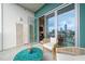 Cozy balcony with wicker chairs, a turquoise table, and a view of the city at 214 Hunt St # 701, Durham, NC 27701