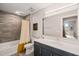 Modern bathroom with a walk-in shower, tile backsplash, and large mirror at 214 Hunt St # 701, Durham, NC 27701
