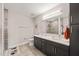 Modern bathroom with double vanity, large mirror, and tiled shower at 214 Hunt St # 701, Durham, NC 27701