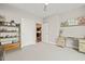Bedroom with a light gray wall and a desk, and a view of the dining room with hardwood floors at 214 Hunt St # 701, Durham, NC 27701