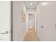 Clean and neutral hallway with carpet flooring and white doors at 214 Hunt St # 701, Durham, NC 27701