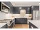 Modern kitchen features stainless steel appliances, undermount lighting, and sleek gray cabinetry at 214 Hunt St # 701, Durham, NC 27701