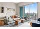 Well-lit living room with balcony access, striped rug, and comfortable seating at 214 Hunt St # 701, Durham, NC 27701