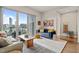 Stylish living room featuring a balcony with city views and hardwood floors at 214 Hunt St # 701, Durham, NC 27701