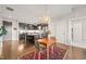 Open-concept space with the dining area flowing into the kitchen and living area with hardwood floors throughout at 214 Hunt St # 701, Durham, NC 27701