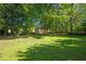 Spacious backyard with mature trees and a storage shed at 2257 Delaney Dr, Burlington, NC 27215