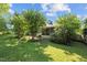 Lush backyard with a screened-in porch and mature landscaping at 2257 Delaney Dr, Burlington, NC 27215