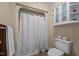Bathroom with a stand up shower, toilet, and storage shelves, and a towel rack at 2257 Delaney Dr, Burlington, NC 27215