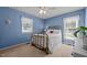 Comfortable bedroom with a brass bed frame, two windows, and a ceiling fan at 2257 Delaney Dr, Burlington, NC 27215