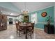 Dining area with vintage table under a golden chandelier next to the kitchen and living room at 2257 Delaney Dr, Burlington, NC 27215