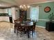 Bright dining room features a classic chandelier, wood furniture, and traditional decor at 2257 Delaney Dr, Burlington, NC 27215