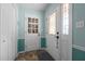 Bright entryway featuring tile floors, white paneled doors, and teal walls with white trim at 2257 Delaney Dr, Burlington, NC 27215