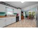 View of the kitchen and dining area with white cabinets, and stainless steel appliances at 2257 Delaney Dr, Burlington, NC 27215
