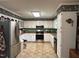 Functional kitchen features white cabinets, stainless steel appliances, and a decorative border at 2257 Delaney Dr, Burlington, NC 27215