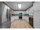 Kitchen with white cabinets, stainless steel appliances and decorative wallpaper running along the ceiling at 2257 Delaney Dr, Burlington, NC 27215