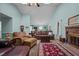 Bright living room with vaulted ceilings, brick fireplace, ceiling fan, and comfortable furnishings at 2257 Delaney Dr, Burlington, NC 27215