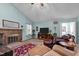 Inviting living room featuring a brick fireplace, comfortable seating, and ample natural light at 2257 Delaney Dr, Burlington, NC 27215