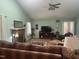 Spacious living room features a fireplace, a ceiling fan, and an abundance of natural light at 2257 Delaney Dr, Burlington, NC 27215
