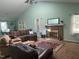 Inviting living room boasts a brick fireplace, high ceilings, and cozy furniture at 2257 Delaney Dr, Burlington, NC 27215