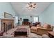 Cozy living room showcasing a brick fireplace, television, and comfortable, plush seating at 2257 Delaney Dr, Burlington, NC 27215
