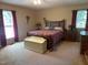Cozy bedroom boasts a comfortable bed, warm carpet, and natural light from two windows at 2257 Delaney Dr, Burlington, NC 27215