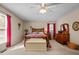 Main bedroom with furniture, carpet flooring, ceiling fan and windows with red drapes at 2257 Delaney Dr, Burlington, NC 27215