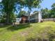 Spacious backyard features a wooden deck, lush lawn, mature trees, and a partial fence, creating a private outdoor oasis at 23 Joci Ct, Durham, NC 27704