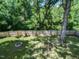 Private backyard with lush green trees, hammock, and fire pit at 23 Joci Ct, Durham, NC 27704