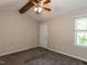 A cozy carpeted bedroom with ceiling fan and natural light at 23 Joci Ct, Durham, NC 27704