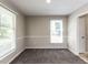 Cozy bedroom with neutral walls, carpet, and ample natural light at 23 Joci Ct, Durham, NC 27704