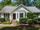Inviting single-story home featuring a well-manicured lawn and lush landscaping at 23 Joci Ct, Durham, NC 27704