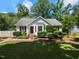 Charming single-story home with manicured lawn and mature trees at 23 Joci Ct, Durham, NC 27704