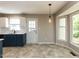 Cozy kitchen with counter seating, tiled floors and a modern light fixture at 23 Joci Ct, Durham, NC 27704