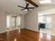 Open-concept living room featuring vaulted ceilings, ceiling fan, and hardwood floors at 23 Joci Ct, Durham, NC 27704
