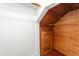Unique attic space with wooden walls and floors featuring a small storage door at 232 S Marshall St, Graham, NC 27253