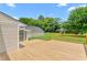 Large wooden deck overlooking the spacious backyard with green trees at 232 S Marshall St, Graham, NC 27253