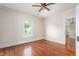 Bright bedroom with hardwood floors, a window overlooking the yard, and neutral paint at 232 S Marshall St, Graham, NC 27253