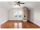 Bedroom with hardwood floors, brick chimney, and double hung windows at 232 S Marshall St, Graham, NC 27253