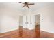 Bedroom features hardwood floors, neutral paint, and open doorways to the rest of the home at 232 S Marshall St, Graham, NC 27253