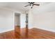 Bright bedroom featuring hardwood floors and view into the ensuite bath at 232 S Marshall St, Graham, NC 27253