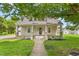 Charming single-story home with a welcoming front porch, green lawn and mature shade trees at 232 S Marshall St, Graham, NC 27253