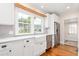 A close up view of the kitchen shows the farmhouse sink and stainless steel appliances at 232 S Marshall St, Graham, NC 27253