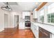 The kitchen offers stainless steel appliances, white cabinets and updated lighting at 232 S Marshall St, Graham, NC 27253