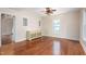 Bright living room with hardwood floors, neutral walls, and a modern ceiling fan fixture at 232 S Marshall St, Graham, NC 27253