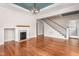 Living room with hardwood floors, a fireplace, and staircase provides a warm gathering space at 232 S Marshall St, Graham, NC 27253