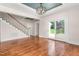 Living room with staircase, hardwood floors, and exterior access for ease of entertaining at 232 S Marshall St, Graham, NC 27253
