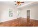 Spacious living room with hardwood floors, white trim, and a view of the front porch through the window at 232 S Marshall St, Graham, NC 27253