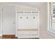 Well-organized mudroom with built-in bench, storage, and hooks near the entrance at 232 S Marshall St, Graham, NC 27253